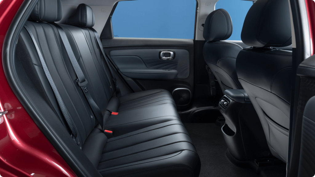 rear passenger interior of the aion ut showing seating, door trim and panoramic glass roof